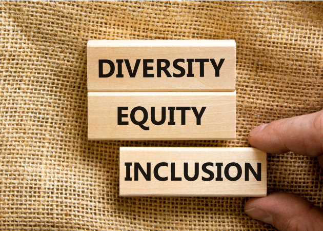 Three small wooden blocks with the words “Diversity,” “Equity” and “Inclusion”