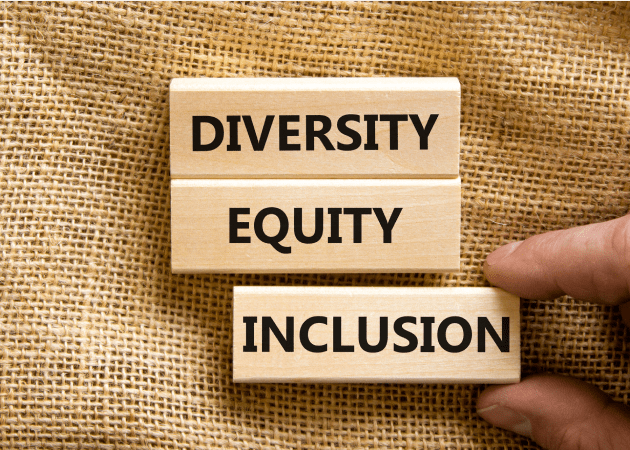 Three small wooden blocks with the words “Diversity,” “Equity” and “Inclusion”