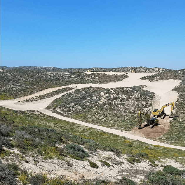An active project site on sand dune landscape with specialized machinery