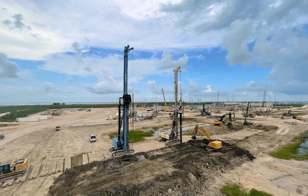 Project site with specialized equipment, including rigging drills and excavators
