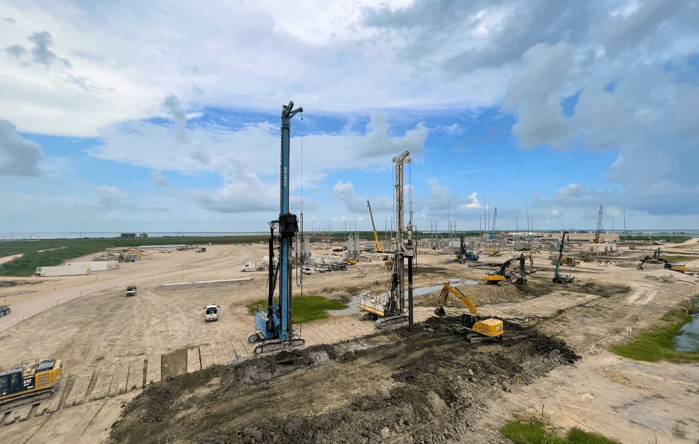 Project site with specialized equipment, including rigging drills and excavators