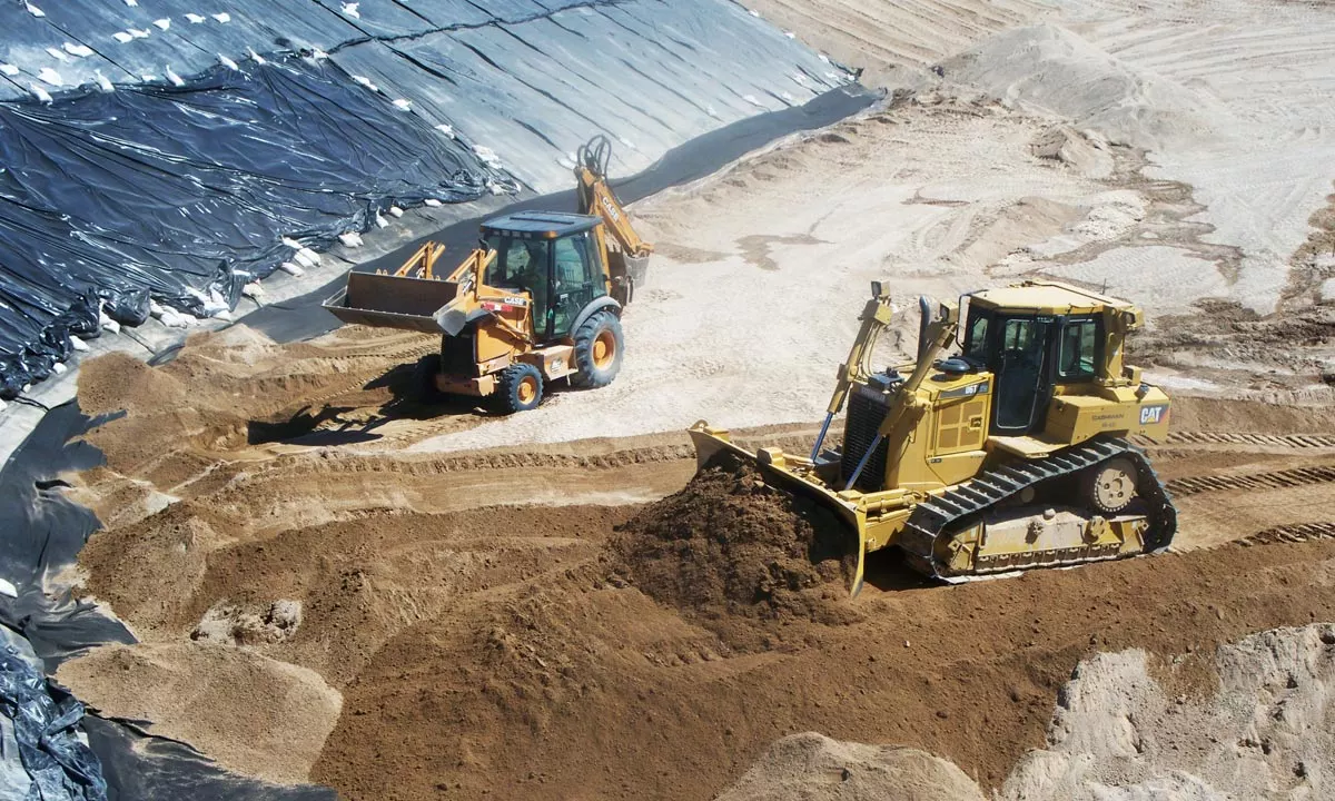 trucks scooping loads of dirt