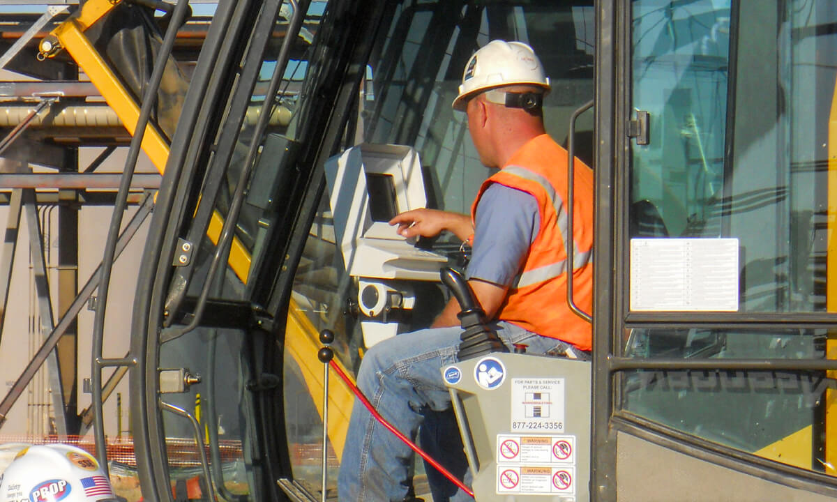 entact worker operating an excavator