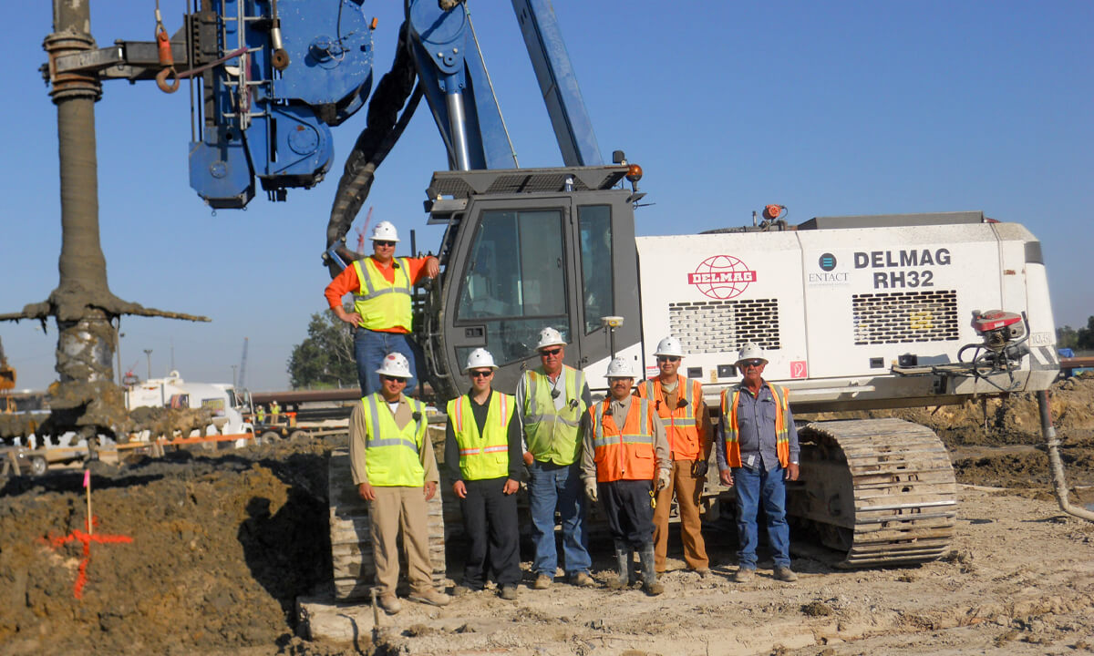 group of entact workers smiling for a picture