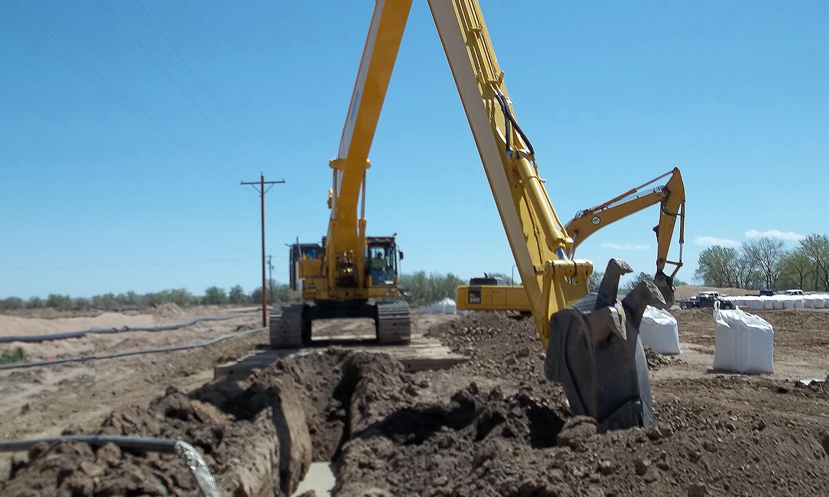 excavator digging a hole for a trench