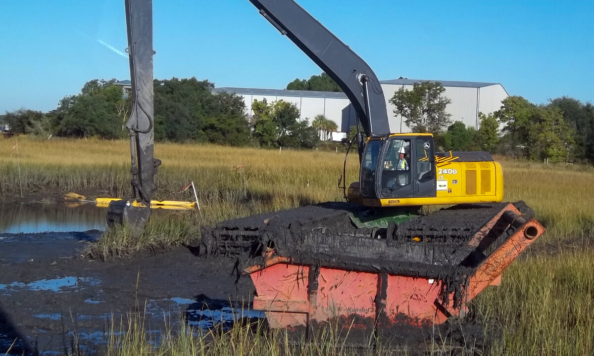 excavator digging out a pond