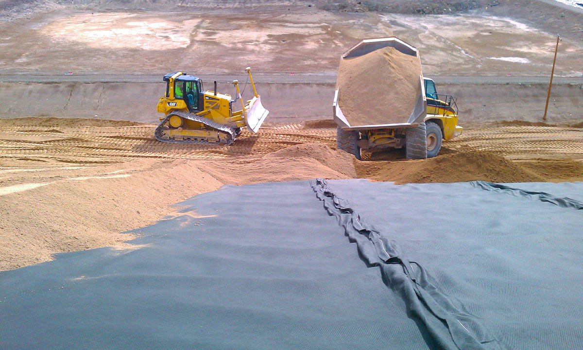 flatbed trucks carrying tons of dirt